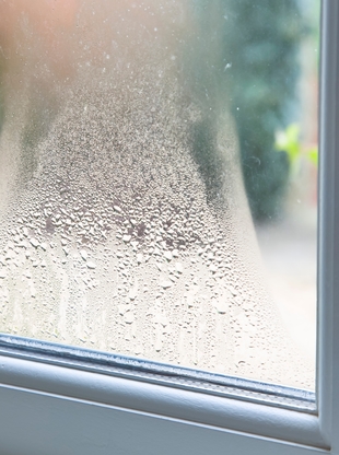 Window with water condensation from dramatic temperature changes